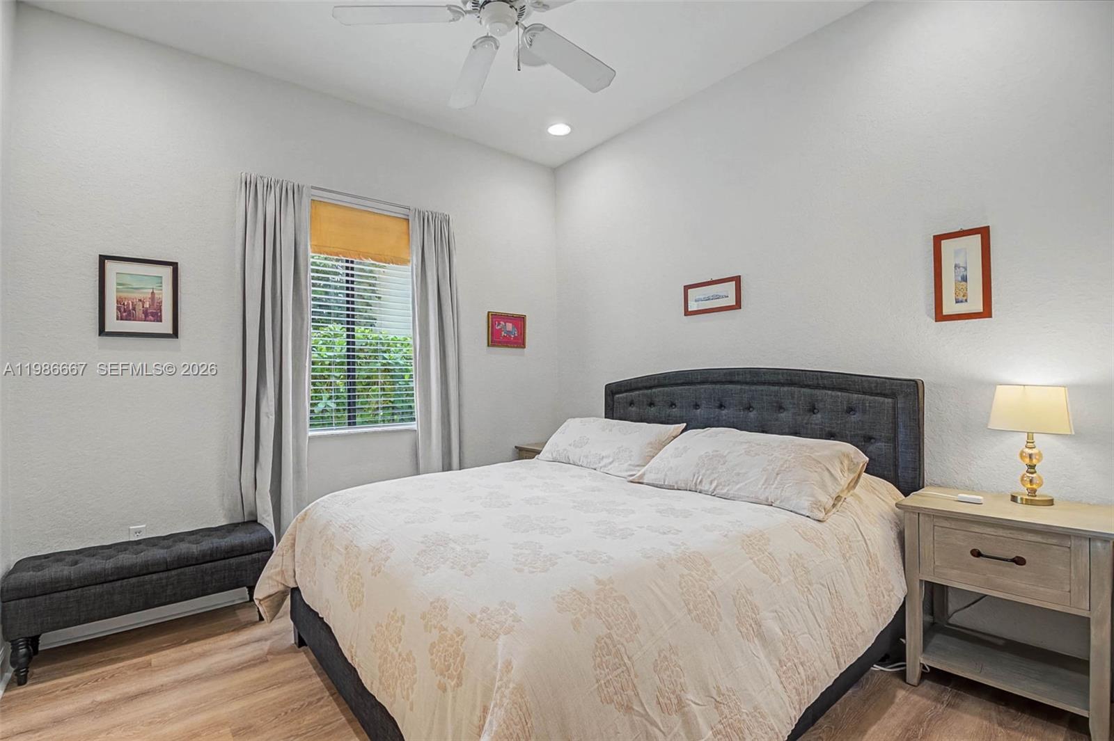 19528 Southwest 79th Place Cutler Bay, FL 33157 - Photo 18 of 41 a bedroom with a large bed and a window