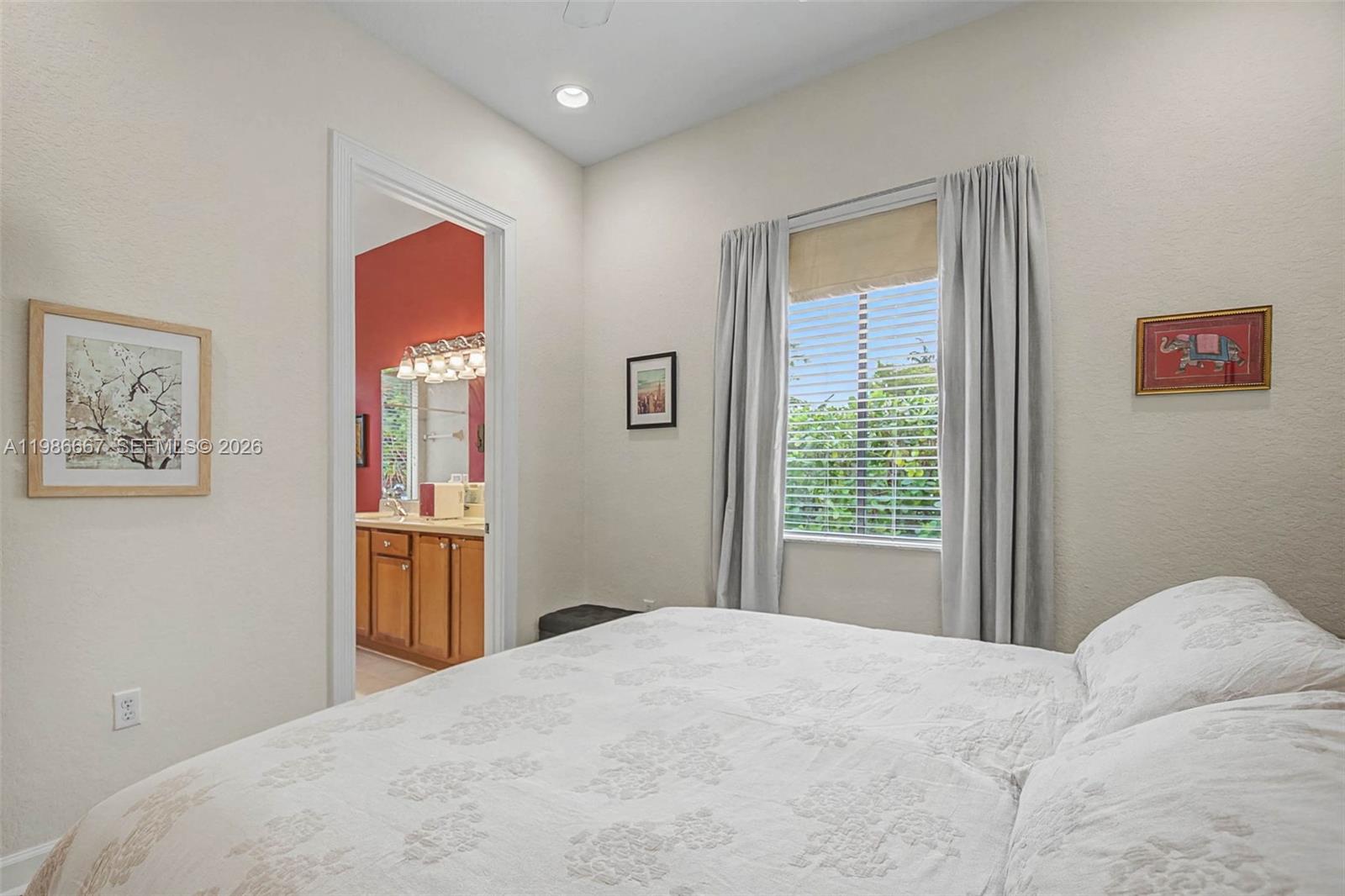 19528 Southwest 79th Place Cutler Bay, FL 33157 - Photo 19 of 41 a bedroom with a large bed and a window