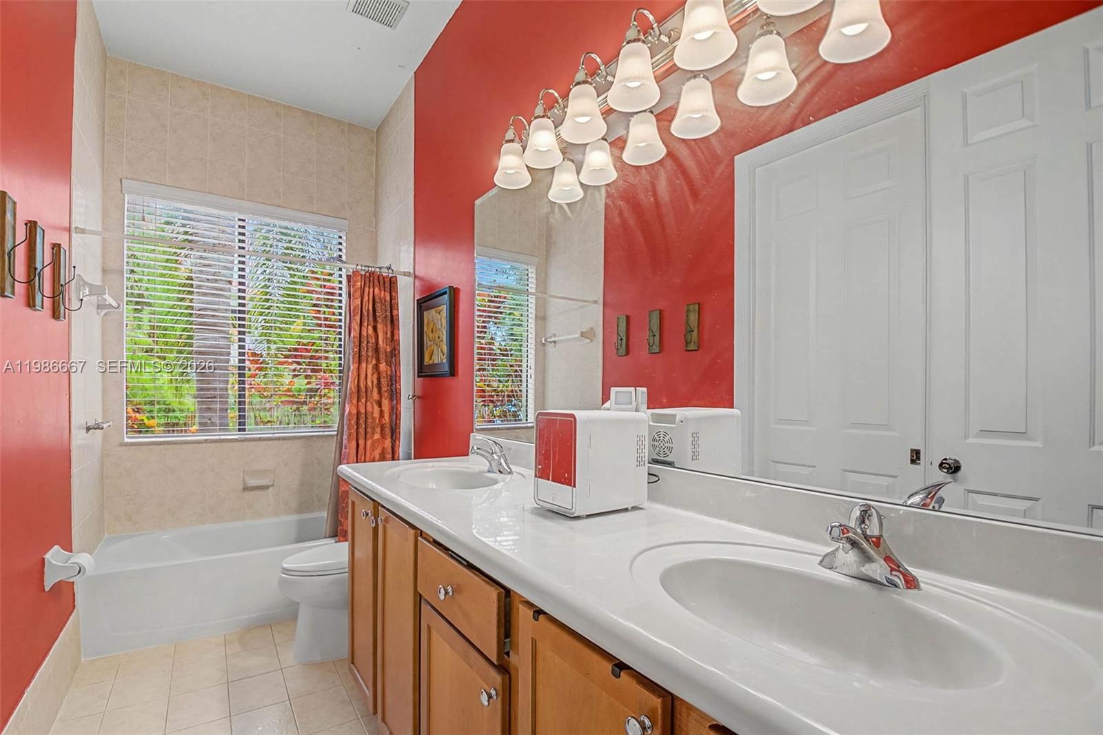 19528 Southwest 79th Place Cutler Bay, FL 33157 - Photo 20 of 41 a bathroom with a granite countertop sink a toilet and a bathtub