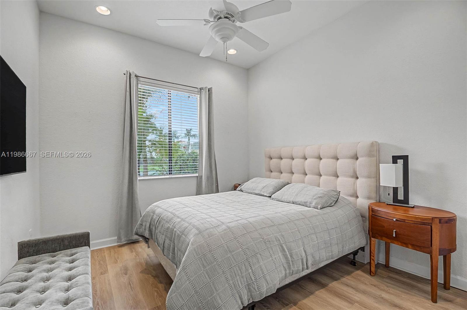 19528 Southwest 79th Place Cutler Bay, FL 33157 - Photo 22 of 41 a bedroom with a bed and a lamp on dresser