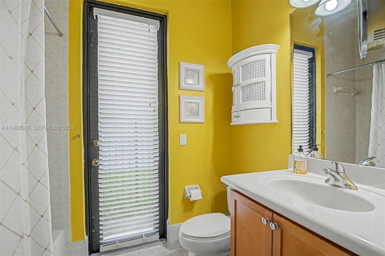 19528 Southwest 79th Place Cutler Bay, FL 33157 - Photo 23 of 41 a bathroom with a granite countertop sink toilet and shower