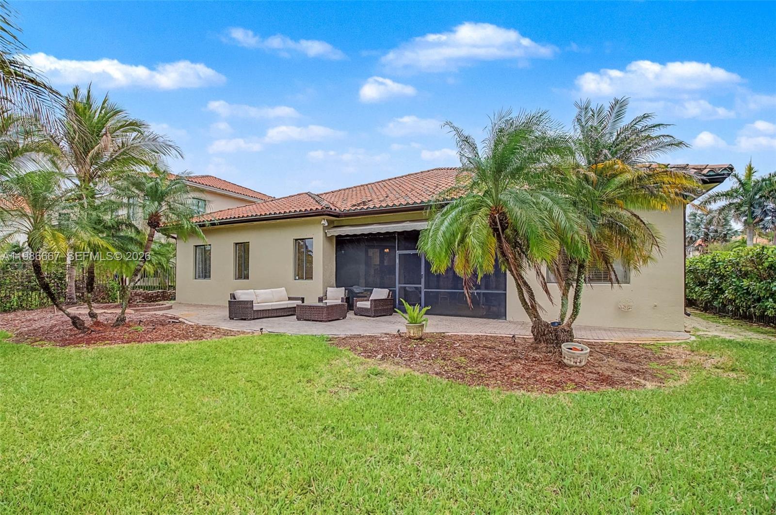 19528 Southwest 79th Place Cutler Bay, FL 33157 - Photo 29 of 41 a view of a house with a backyard and a patio
