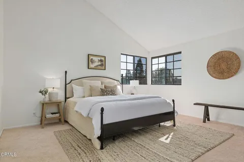 a large room with a bed and window