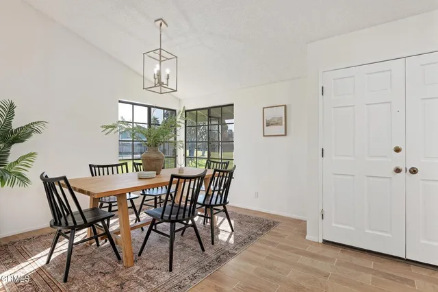 a view of a dining room with furniture window and wooden floor