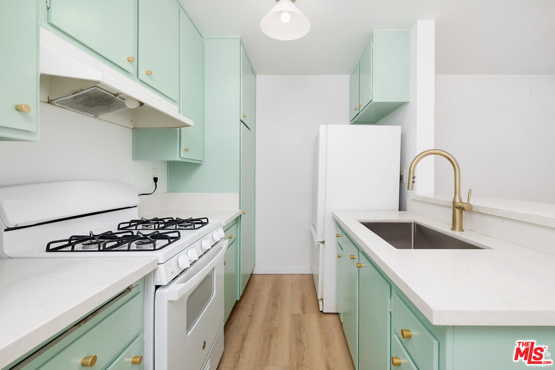 114 South Gramercy Place, Unit 108 Los Angeles, CA 90004 - Photo 1 of 8 a kitchen that has a sink and a stove