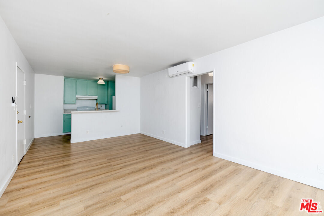 114 South Gramercy Place, Unit 108 Los Angeles, CA 90004 - Photo 2 of 8 a view of empty room with wooden floor and window