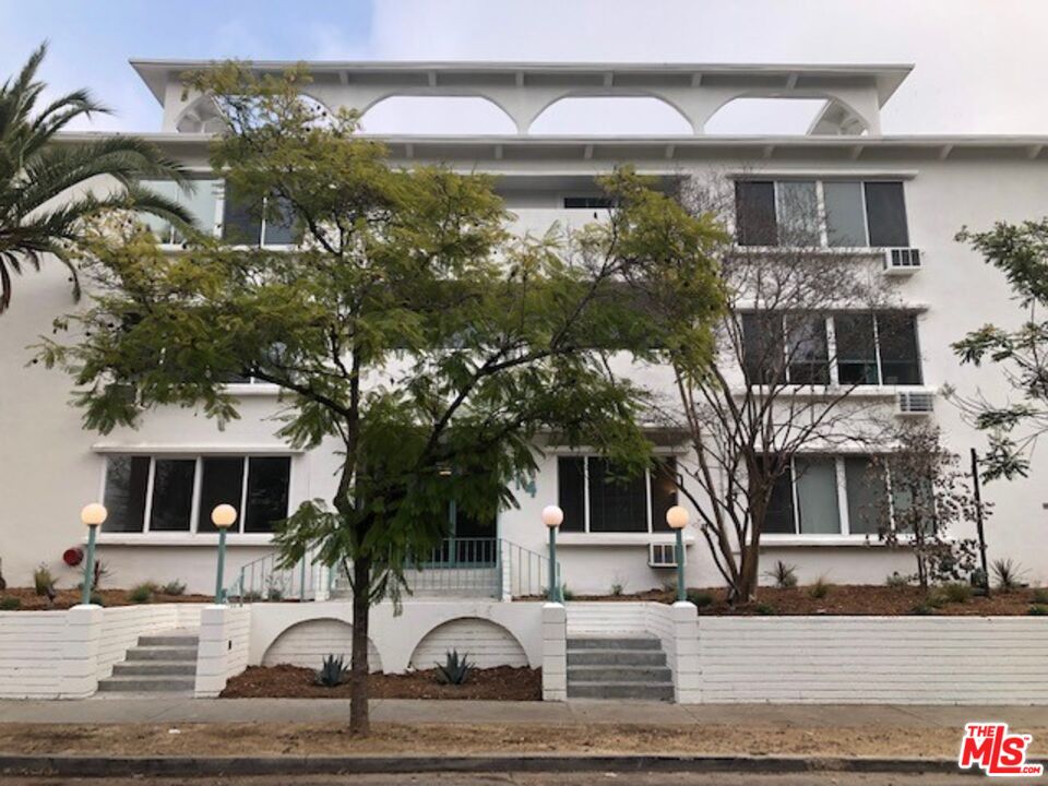 114 South Gramercy Place, Unit 108 Los Angeles, CA 90004 - Photo 6 of 8 a front view of a house with a yard
