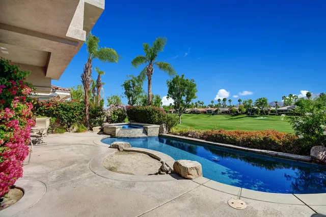 a view of a backyard with plants and outdoor seating