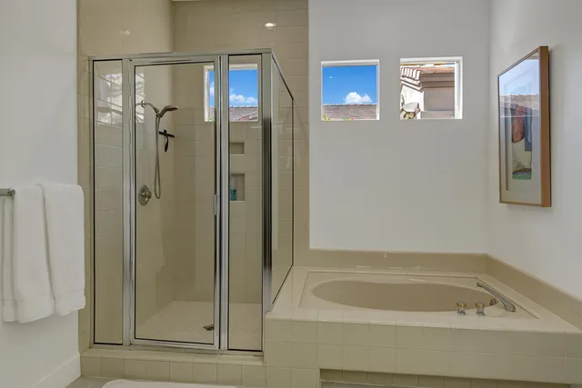 a bathroom with a bathtub and a shower
