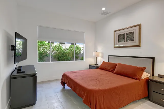 a bedroom with furniture and a window