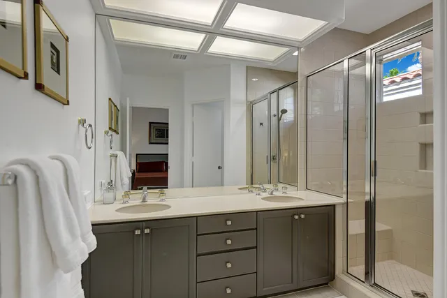 a bathroom with a double vanity sink mirror and double
