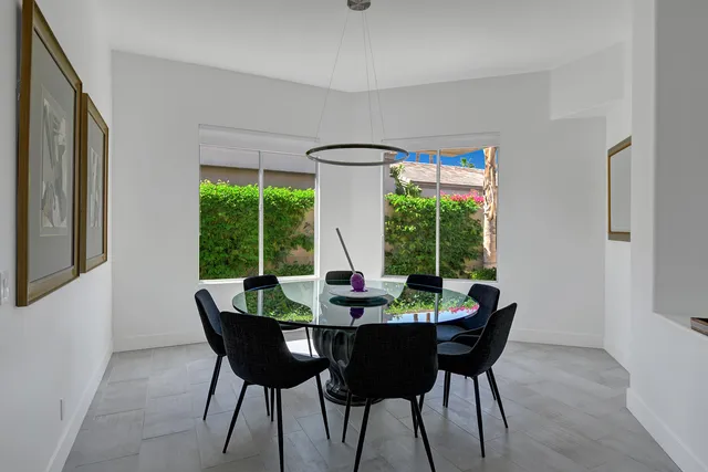 a dining room with furniture window and outside view