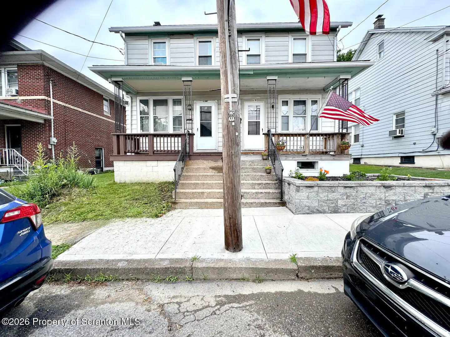 a view of a brick building with a yard and sitting area