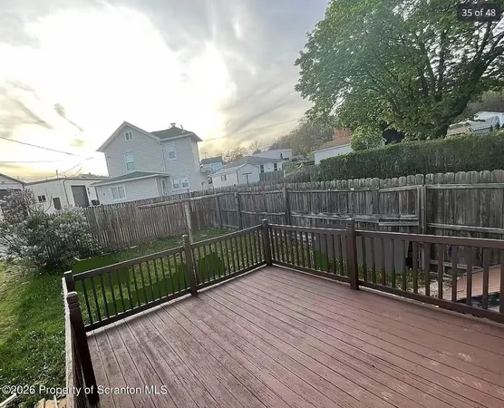 a view of a roof with wooden floor and fence