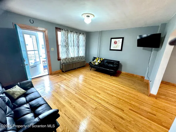 a bedroom with furniture and a flat screen tv