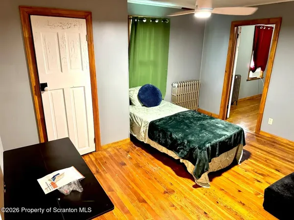 a bedroom with a bed and a mirror