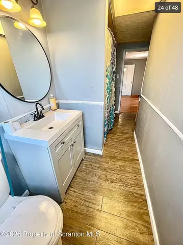 a bathroom with a toilet sink and mirror