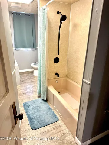 a bathroom with a bathtub and a shower