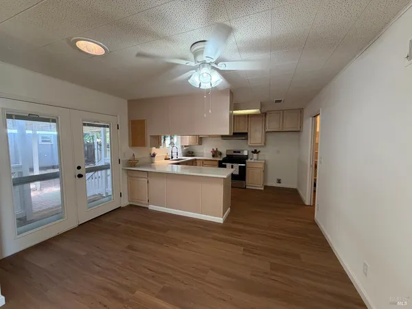 a kitchen with a refrigerator and a stove top oven