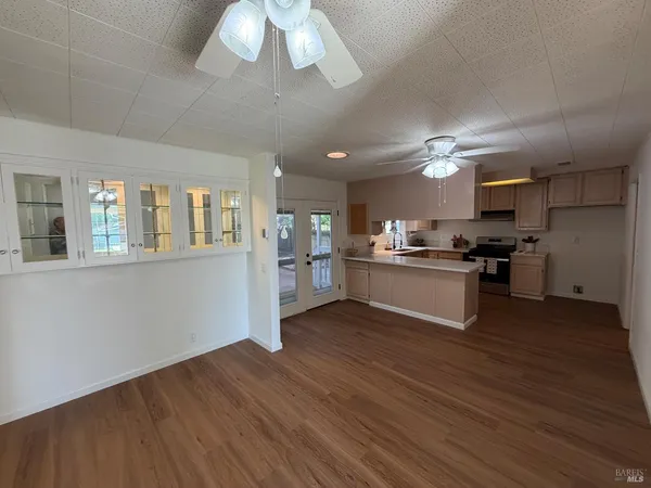 a view of kitchen with cabinets and wooden floor