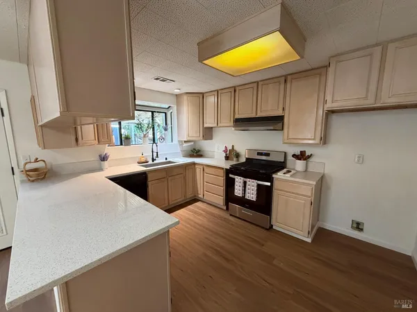 a kitchen with sink cabinets and wooden floor