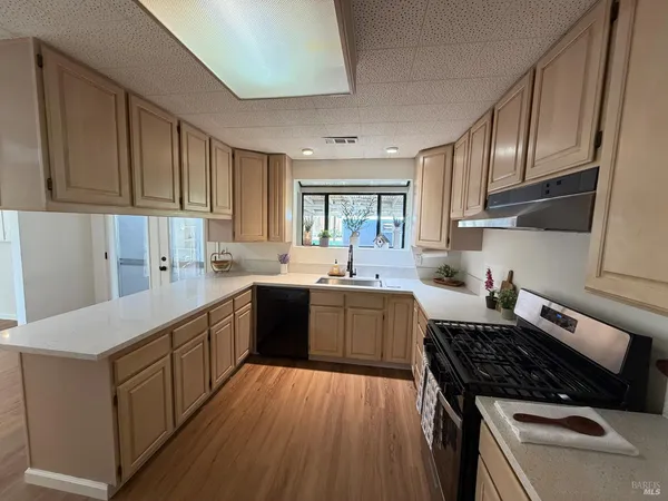 a kitchen with wooden floors and a stove top oven