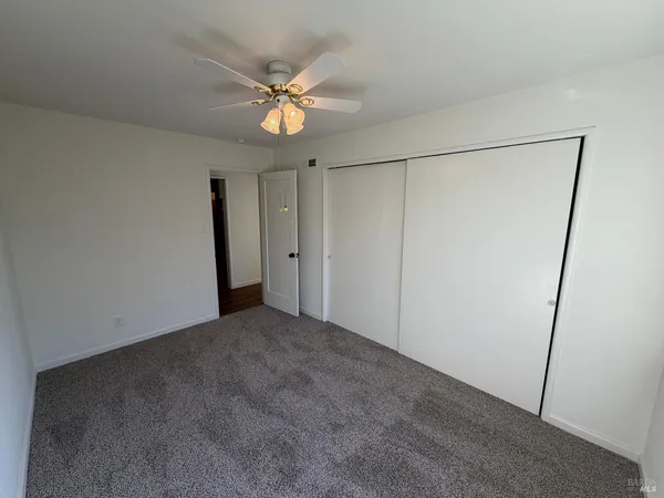 a view of a room with a fan and a fan