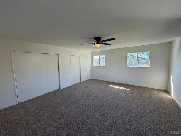 a view of an empty room with windows