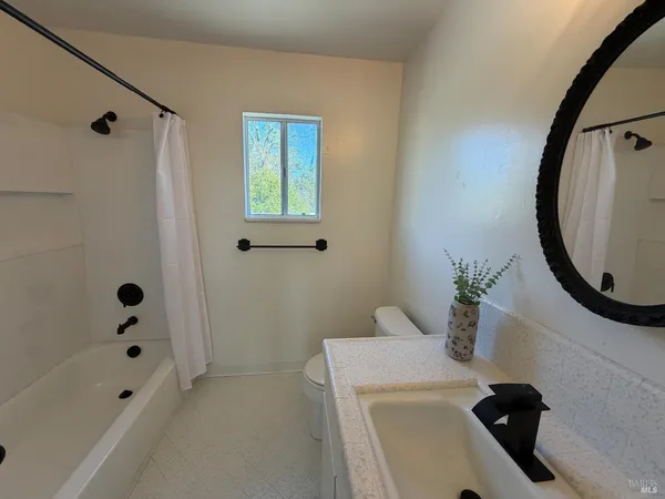 a bathroom with a sink toilet and tub