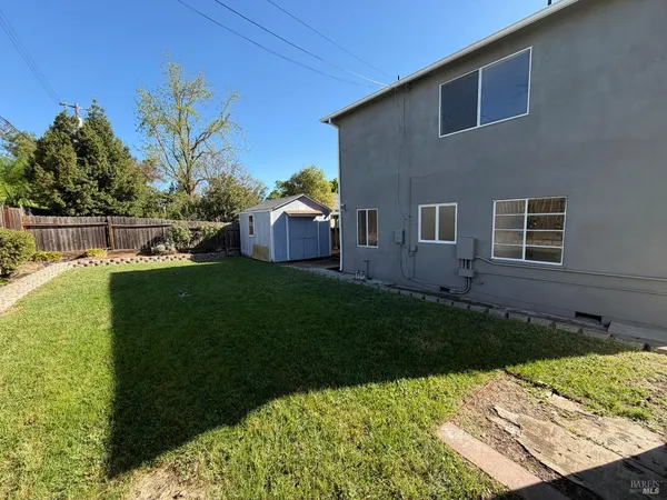 a view of a backyard with potted plants