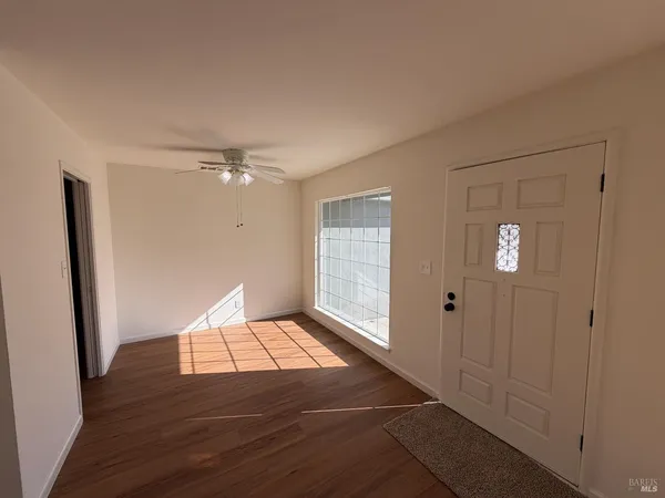 a view of an empty room and wooden floor