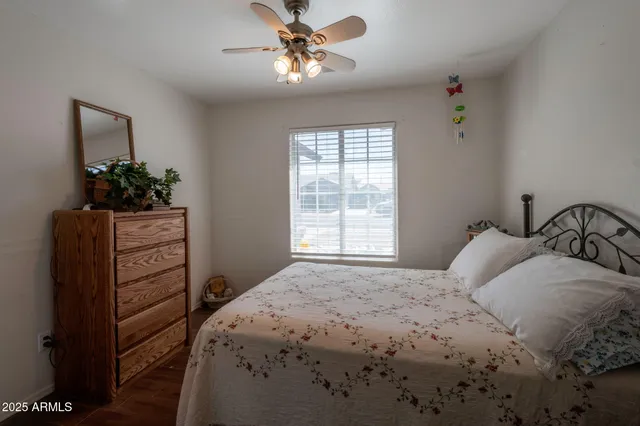 a bedroom with a bed and a potted plant