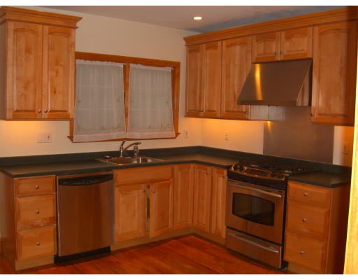 206 Winslow Road Newton, MA 02468 - Photo 5 of 9 a kitchen with granite countertop wooden cabinets and a stove top oven