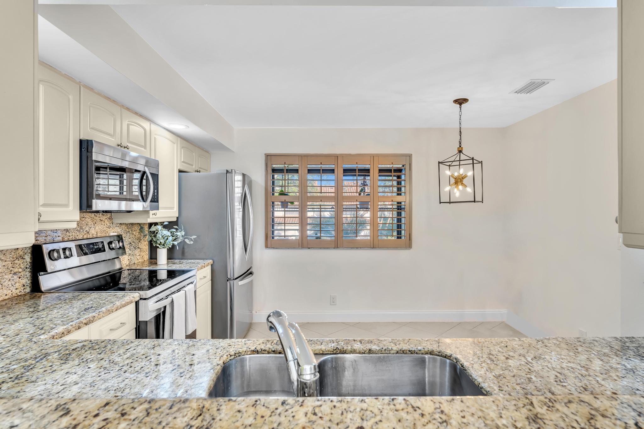 7718 La Mirada Drive Boca Raton, FL 33433 - Photo 14 of 56 Dining view to kitchen
