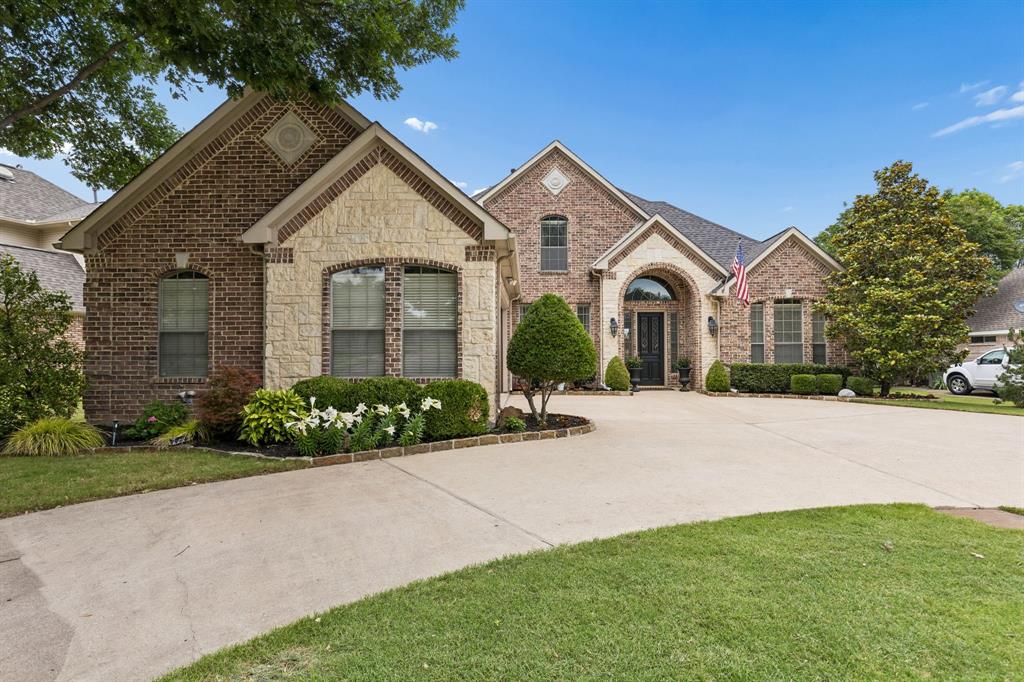 8517 Navigation Drive Rowlett, TX 75088 - Photo 2 of 39 a front view of a house with a garden and plants