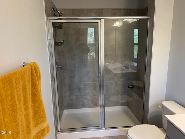 a bathroom with a shower and toilet