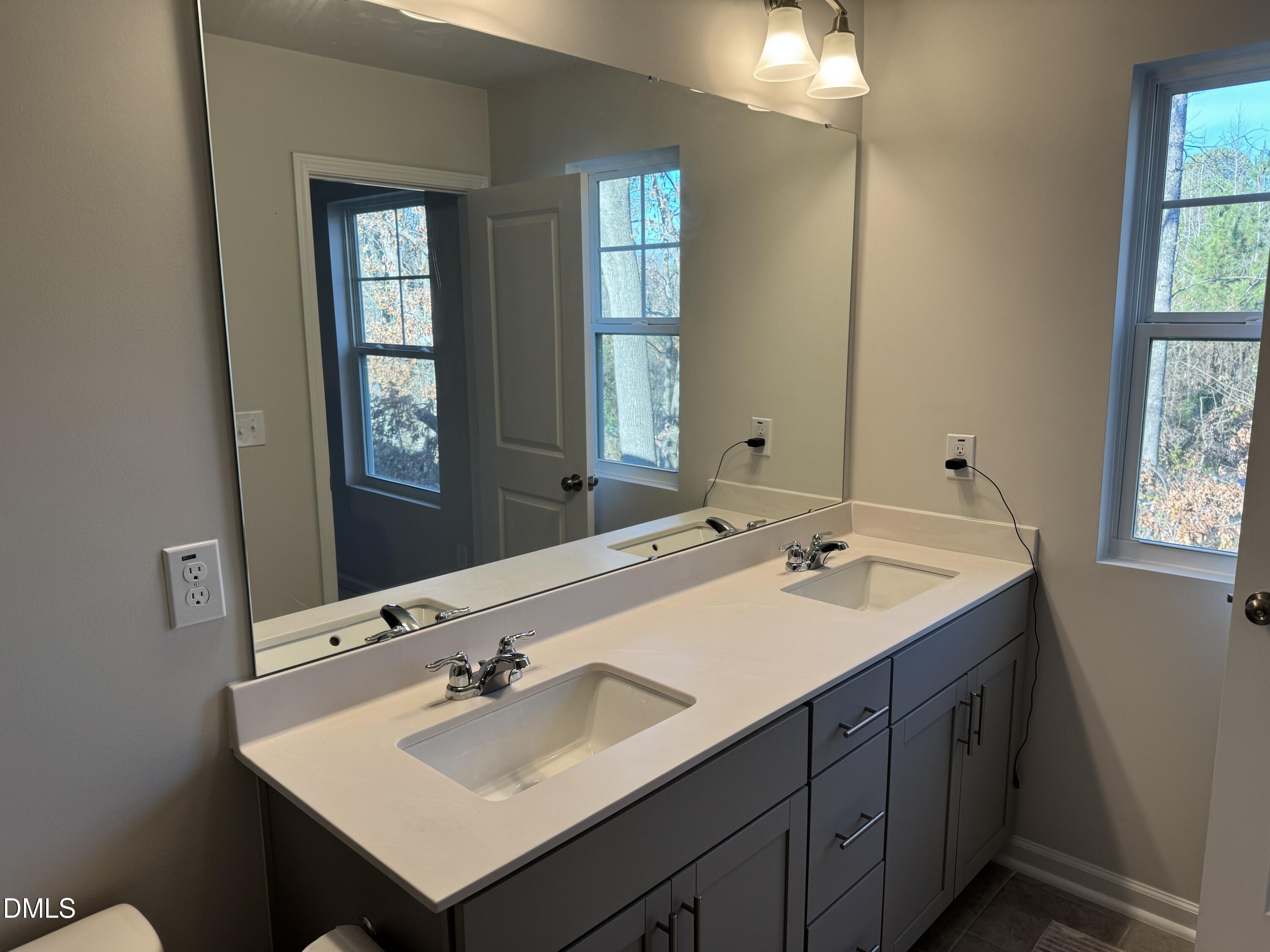237 Peebles Drive Smithfield, NC 27577 - Photo 15 of 21 a bathroom with a sink and a mirror