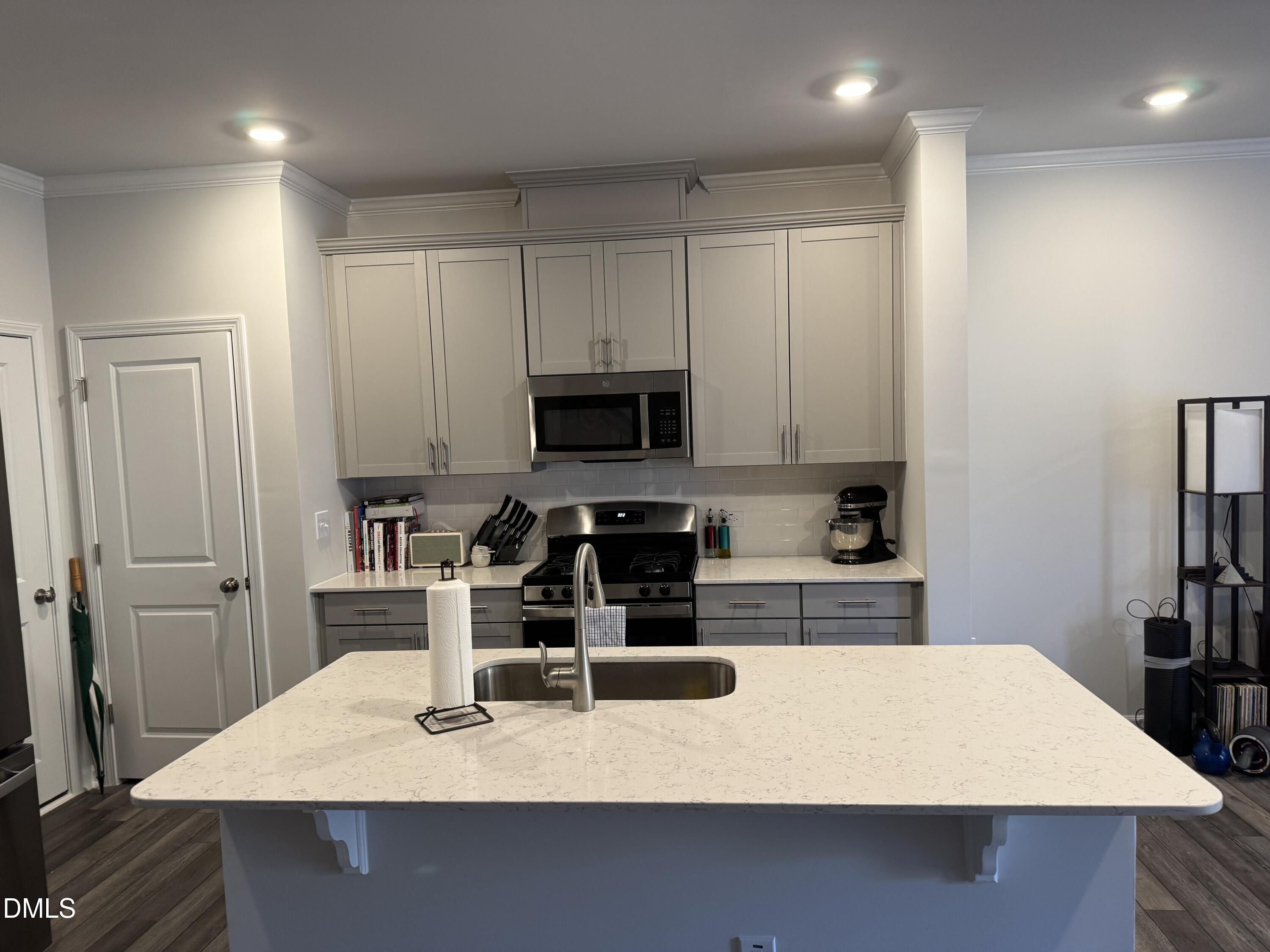 237 Peebles Drive Smithfield, NC 27577 - Photo 2 of 21 a kitchen with kitchen island a sink a stove and a refrigerator