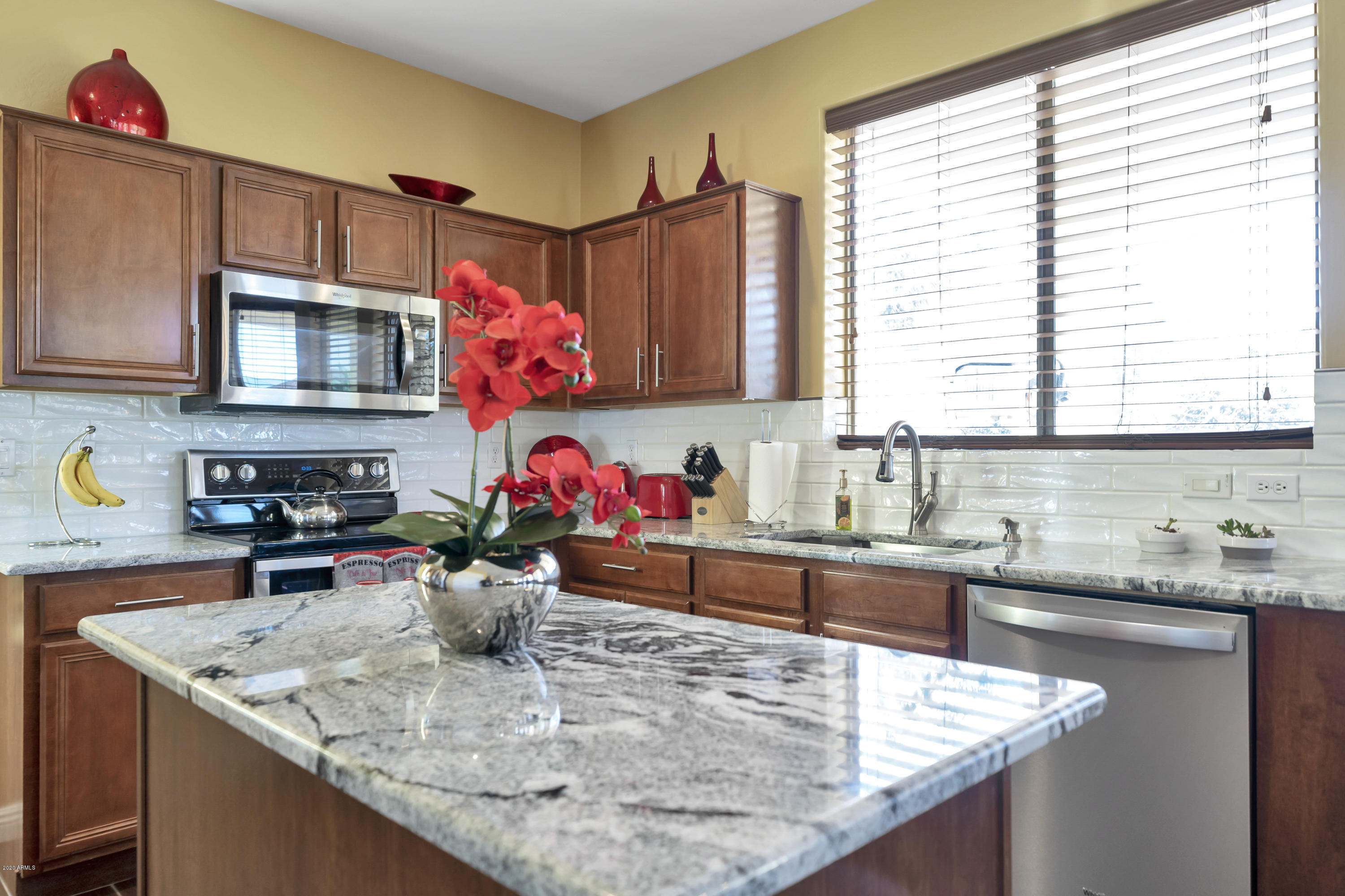 14103 West Bloomfield Road Surprise, AZ 85379 - Photo 17 of 51 a kitchen with stainless steel appliances granite countertop a sink window and cabinets