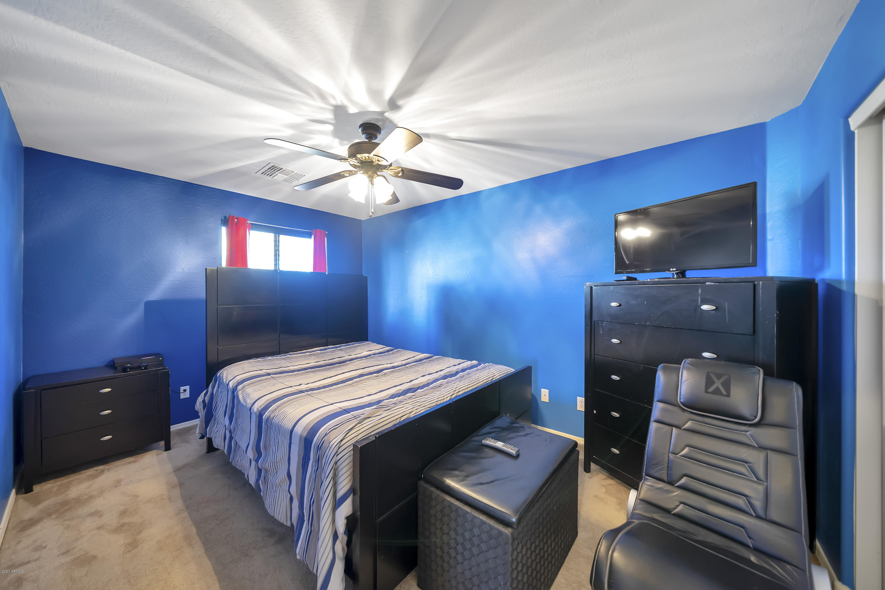 14103 West Bloomfield Road Surprise, AZ 85379 - Photo 27 of 51 a bedroom with a bed and a chandelier