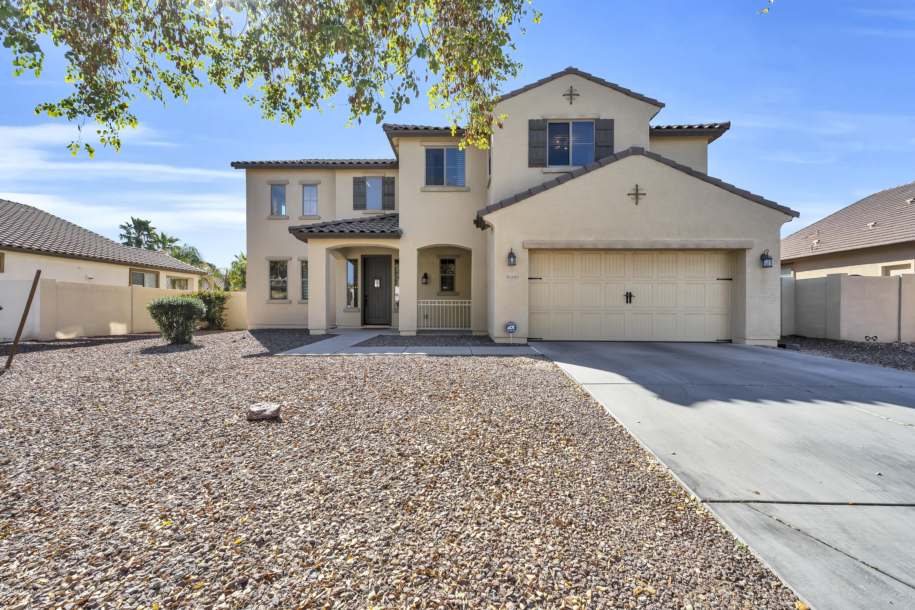 14103 West Bloomfield Road Surprise, AZ 85379 - Photo 3 of 51 a front view of a house with a yard