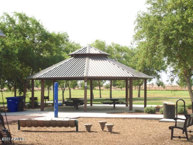 14103 West Bloomfield Road Surprise, AZ 85379 - Photo 49 of 51 a patio with a table and chairs under an umbrella