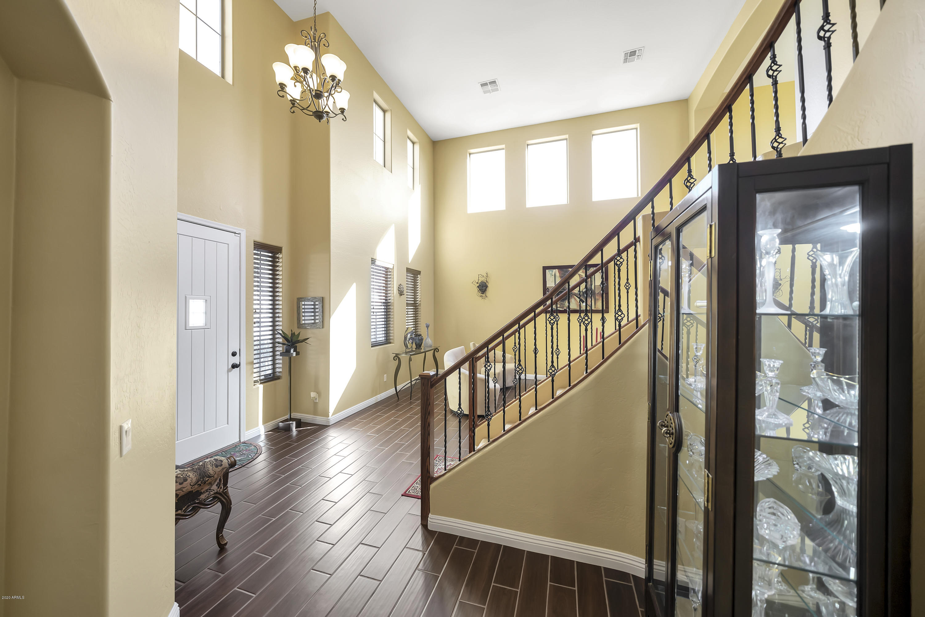 14103 West Bloomfield Road Surprise, AZ 85379 - Photo 9 of 51 a view of an entryway wooden floor and chandelier