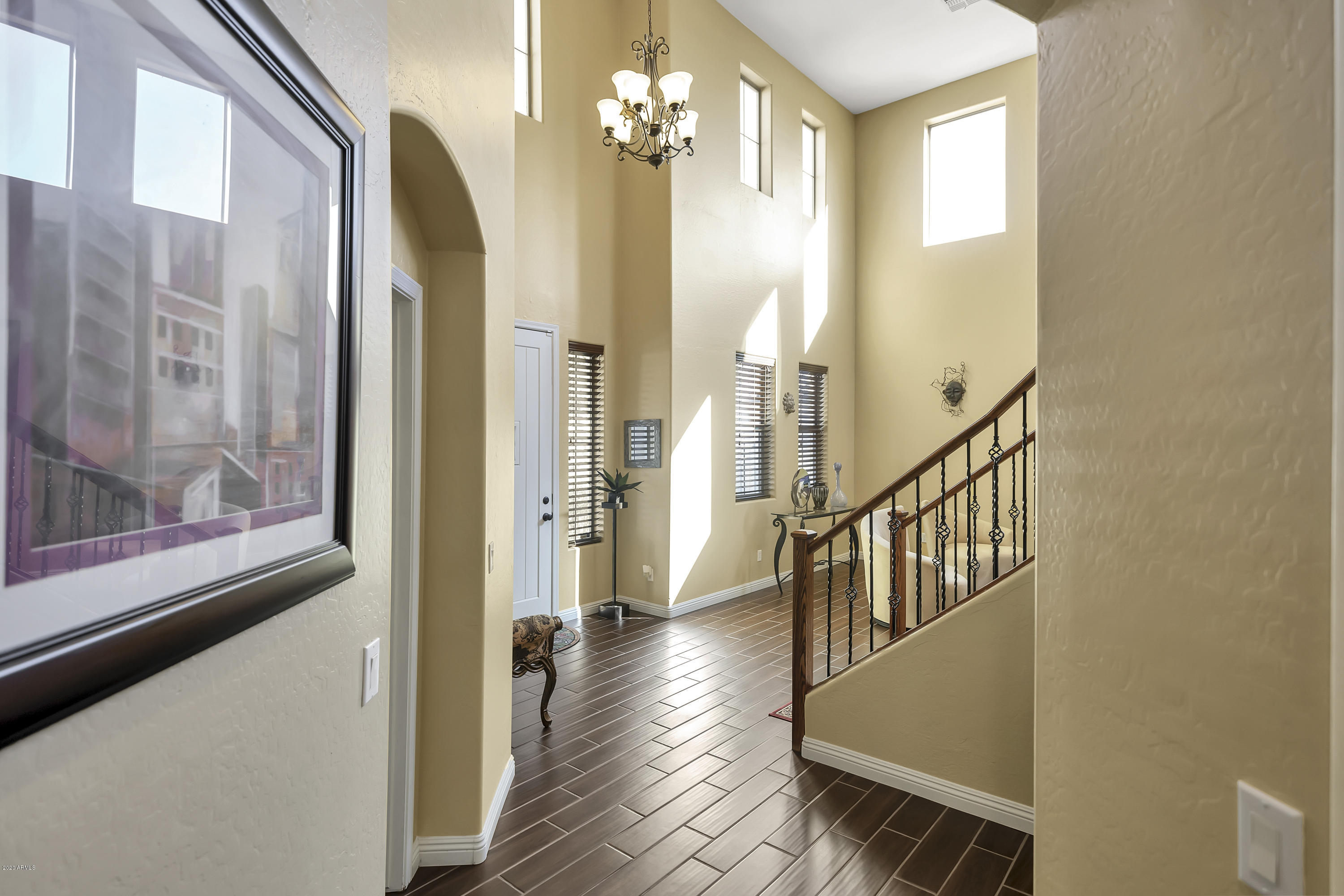 14103 West Bloomfield Road Surprise, AZ 85379 - Photo 10 of 51 a view of a hallway with wooden floor and staircase