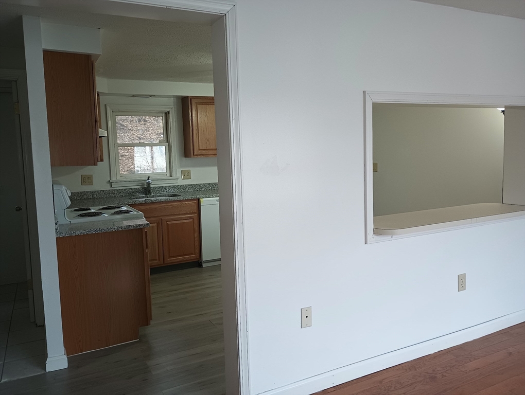 20-3 Rice Lane Worcester, MA 01604 - Photo 6 of 12 a kitchen with stainless steel appliances granite countertop a stove a sink and a refrigerator