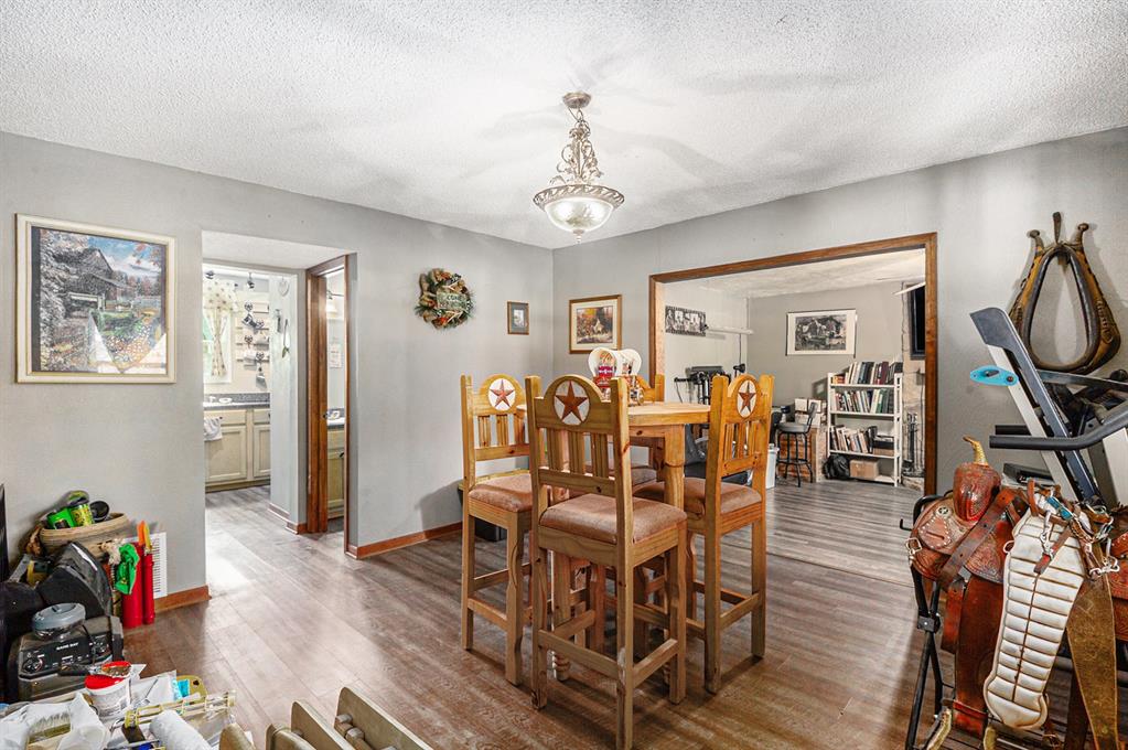 150 County 2110 Road Whitney, TX 76692 - Photo 8 of 21 a view of a dining room with furniture wooden floor and a window