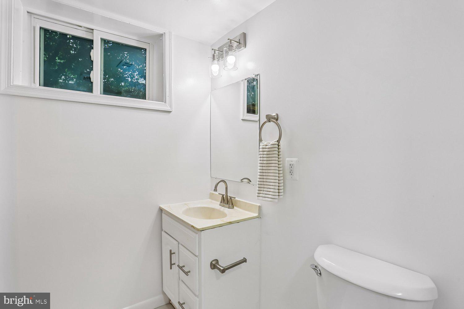 907 Hoyt Street Silver Spring, MD 20902 - Photo 54 of 69 a bathroom with a toilet a sink and mirror