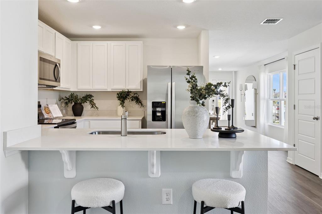 3417 Nettle Loop Tavares, FL 32778 - Photo 13 of 29 a kitchen with stainless steel appliances a sink and a refrigerator