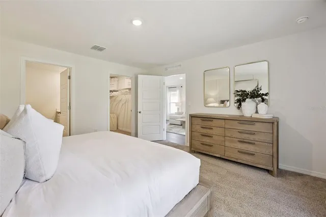 a bedroom with a bed and a dresser