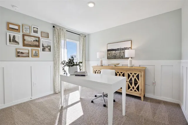a view of a livingroom with furniture and kitchen